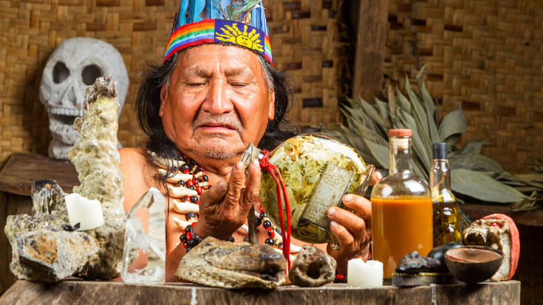 ayahuasca shaman wearing feathered headdress