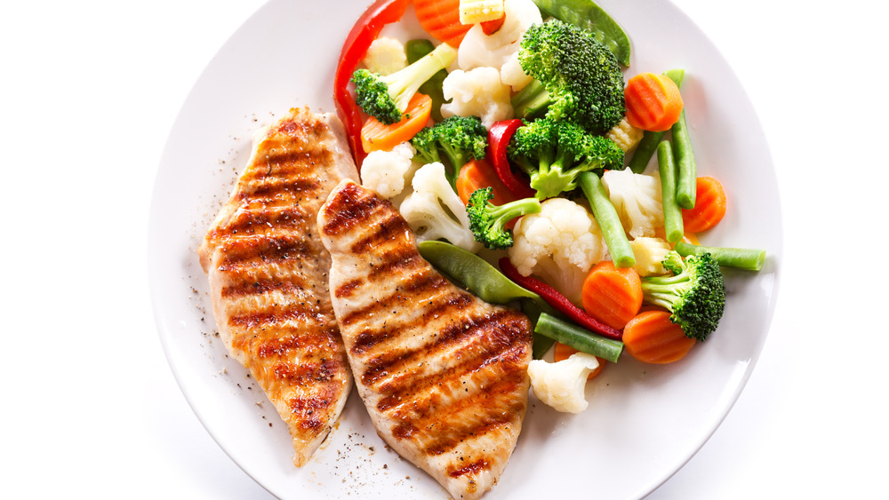 Plate of grilled chicken with vegetables