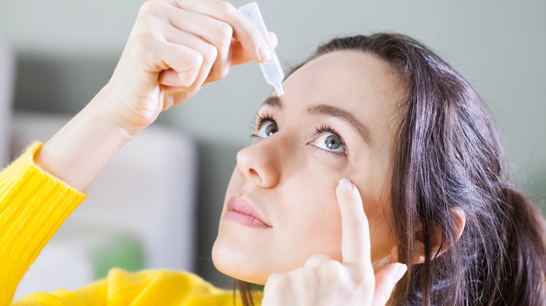 Woman using eye drops