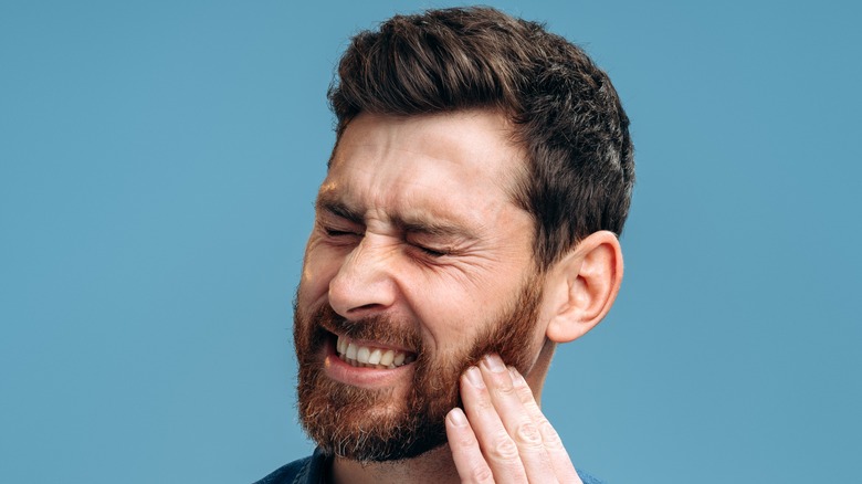 man experiencing tooth pain