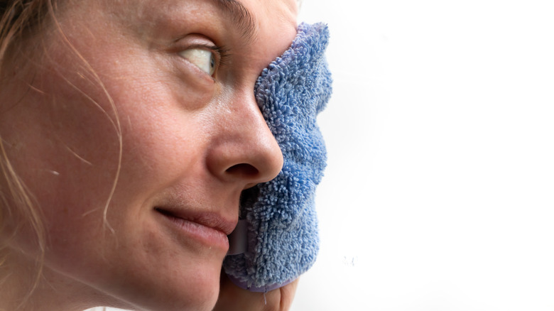 woman using microfiber washcloth to clean face