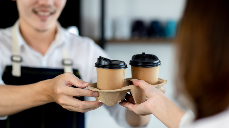 Someone is picking up coffee from a cafe