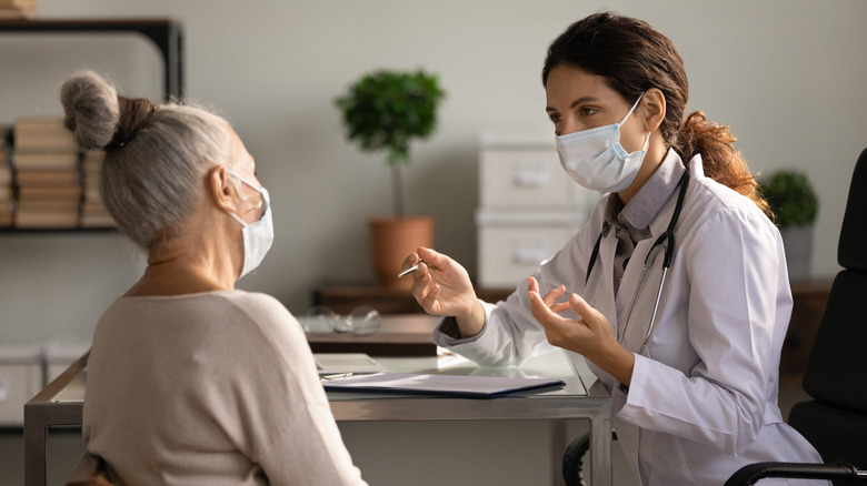 A woman speaks with a doctor