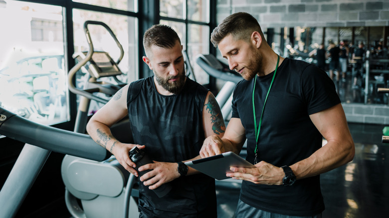 A personal trainer speaks with a client