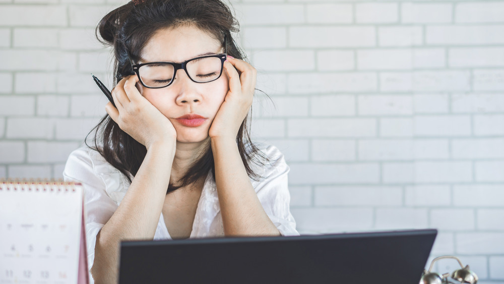 tired woman at desk