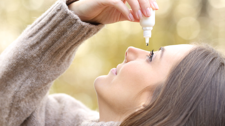 Woman using eye drops