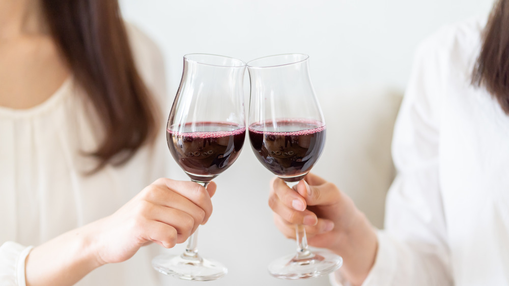 Women clinking wine glasses