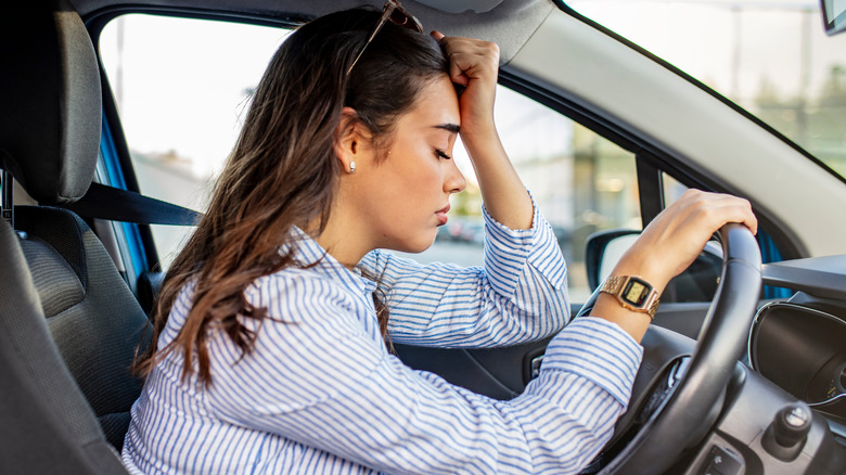 Woman falling asleep while driving in the car