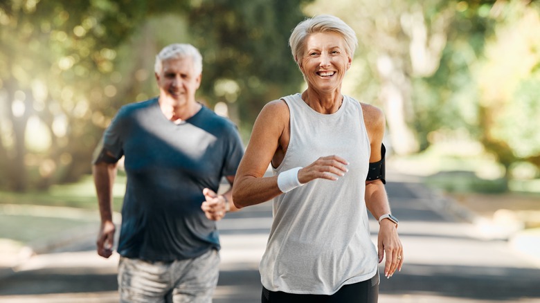 happy older couple walking in the park