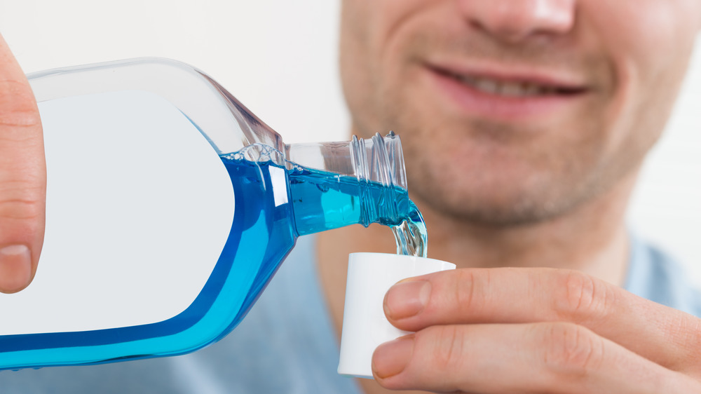 Man pouring mouthwash