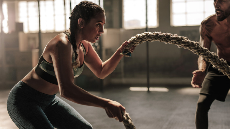 Woman exercising with battle ropes