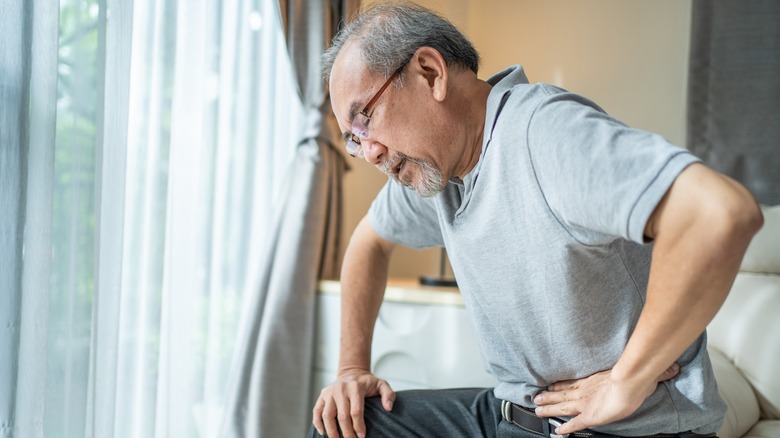 Older man with stomach cramp