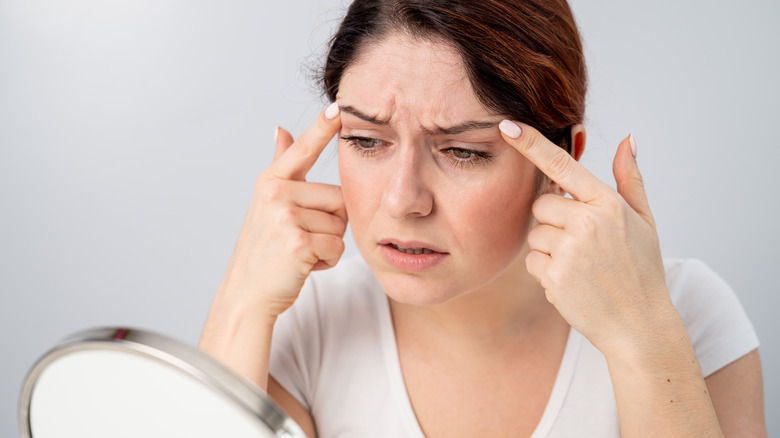 Woman examining wrinkles