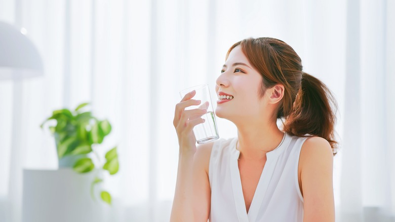 Asian woman drinks water