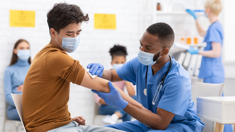 Doctor giving vaccine to patient 