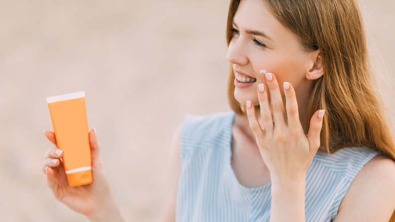 Woman applying sunscreen