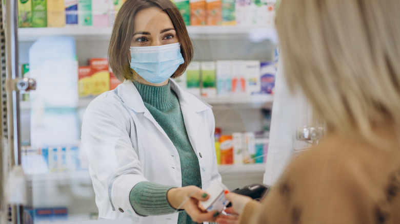 customer buying medication from pharmacist