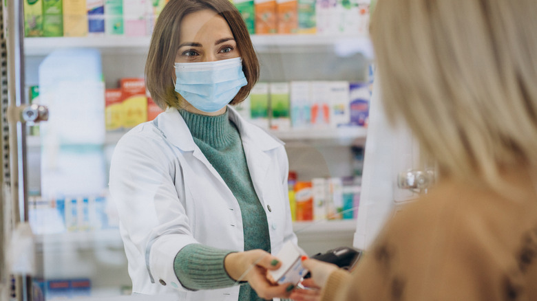 customer buying medication from pharmacist