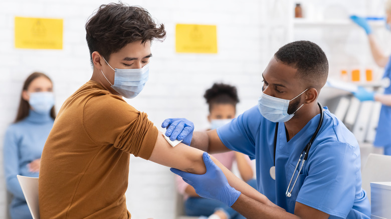 Nurse giving man a COVID-19 shot