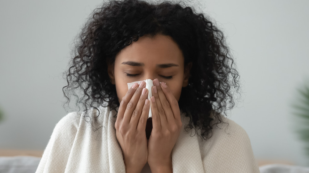 woman blowing nose