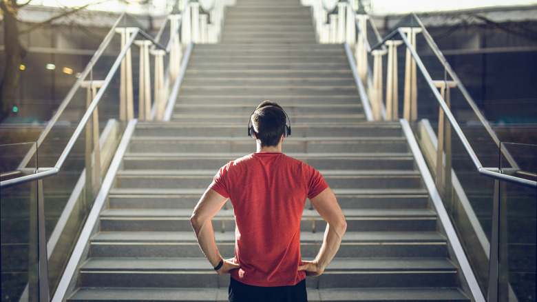 man looking up stairs