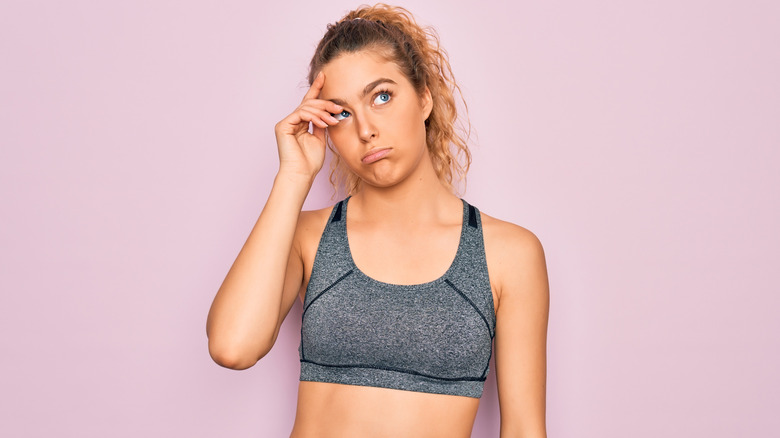 confused woman in workout gear