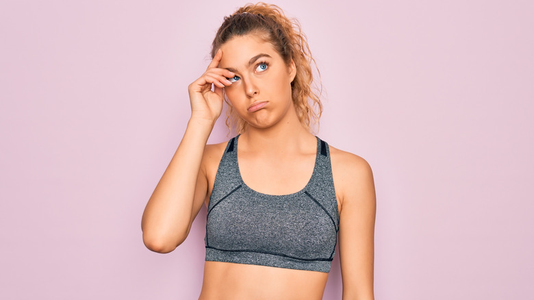 confused woman in workout gear