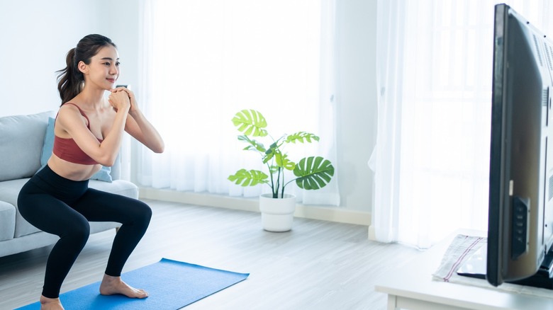 Woman working out watching TV