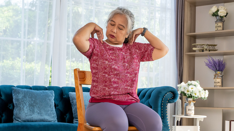 older woman doing chair workout