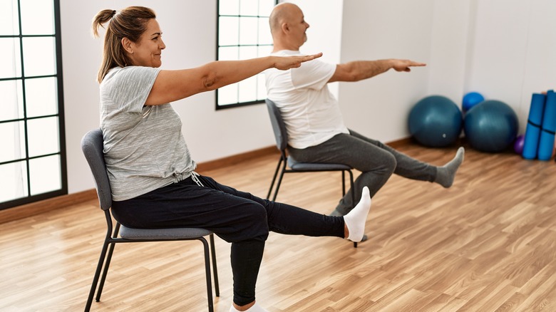 couple working out on chairs