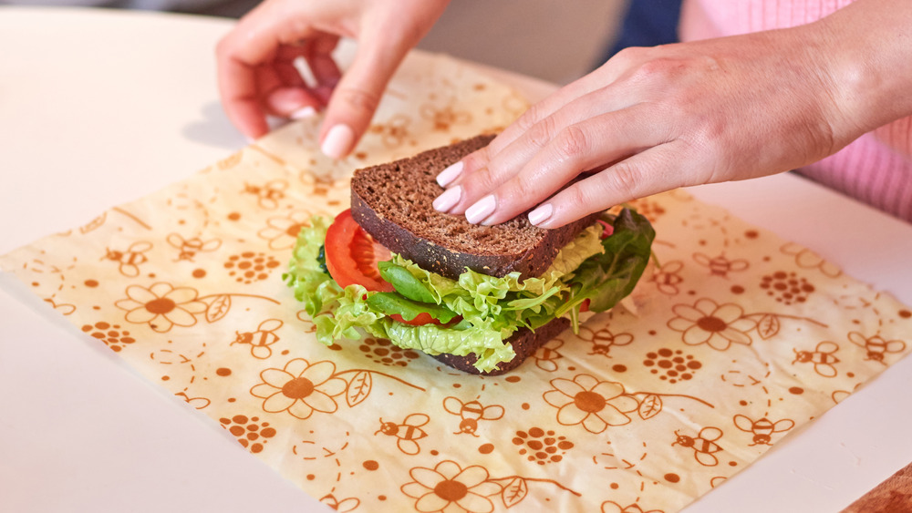 Sandwich loaded with vegetables on a cutting board