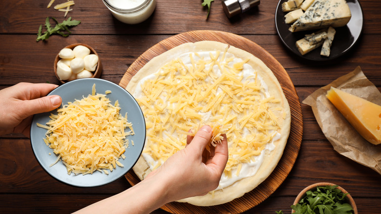 Woman using grated cheese