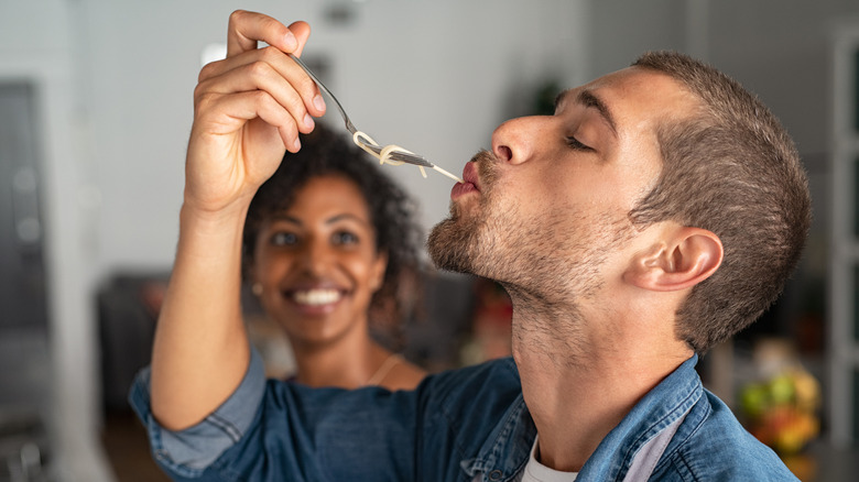 Man tasting pasta