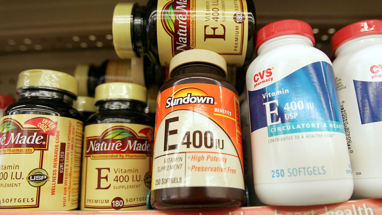 Bottles of vitamin E stacked on a shelf 