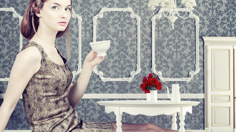 woman drinking tea in a small room