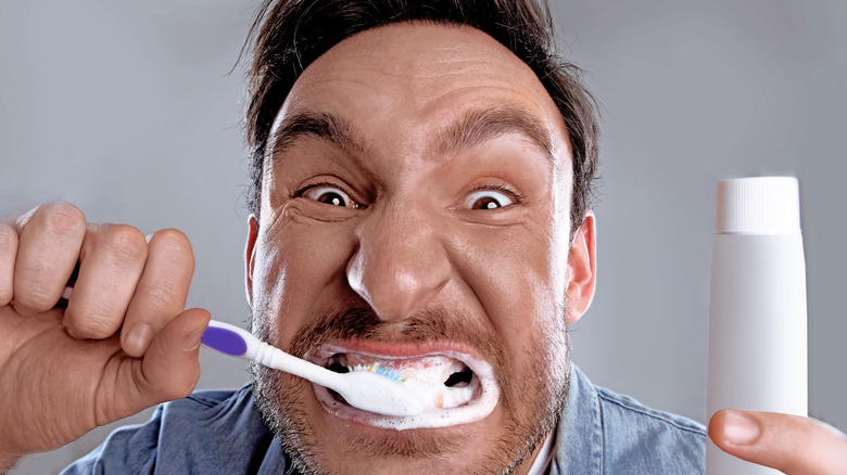 man brushing teeth aggressively