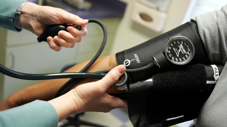 A medical provider taking someone's blood pressure