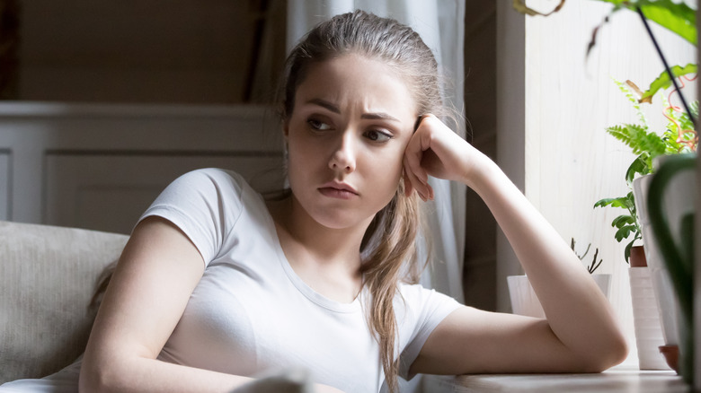 Anxious woman by the window