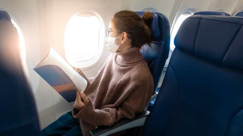 A woman flies on an airplane