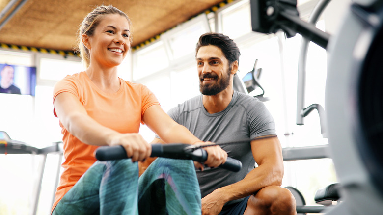 Woman exercising with personal trainer