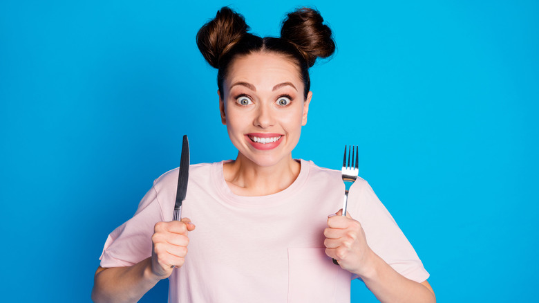 hungry woman with fork and knife