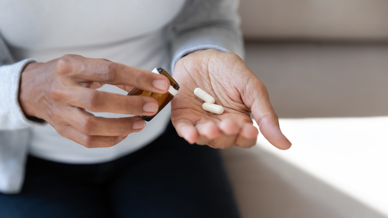 Pills and bottle in hands