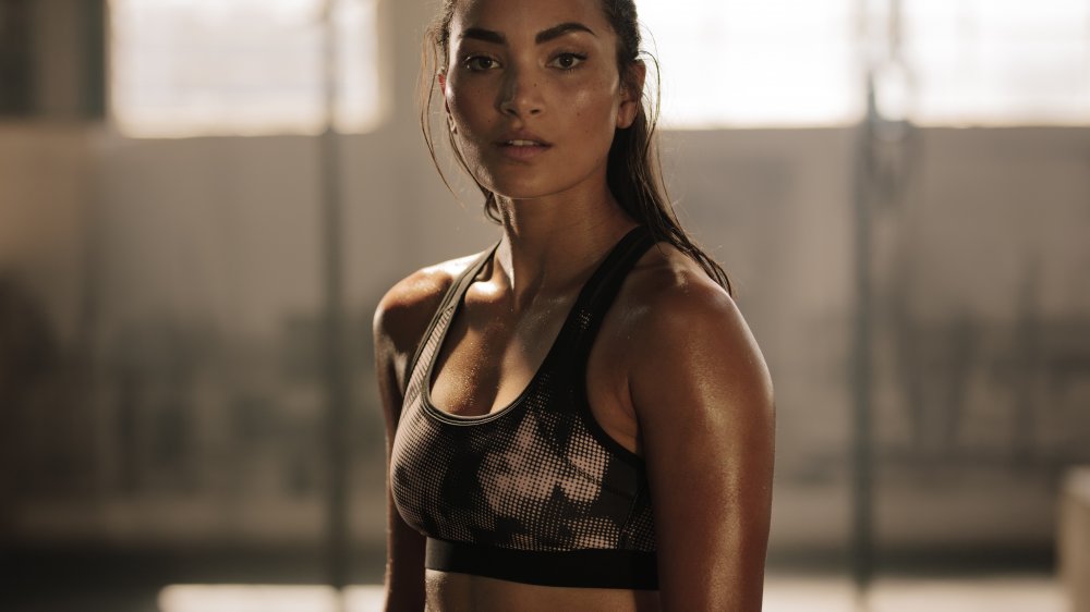 A strong woman sweating at the gym 