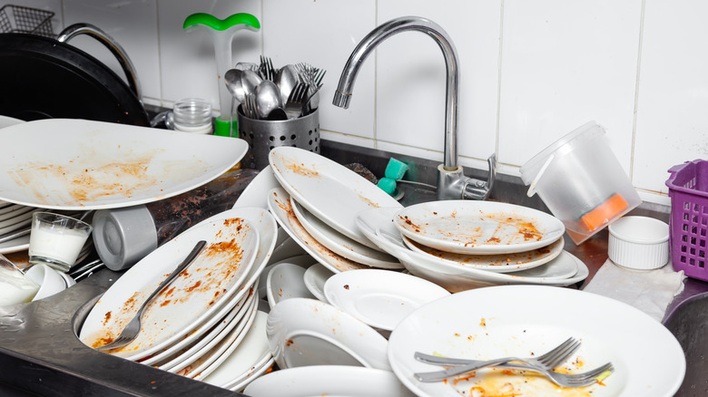 dishes piled up in a sink