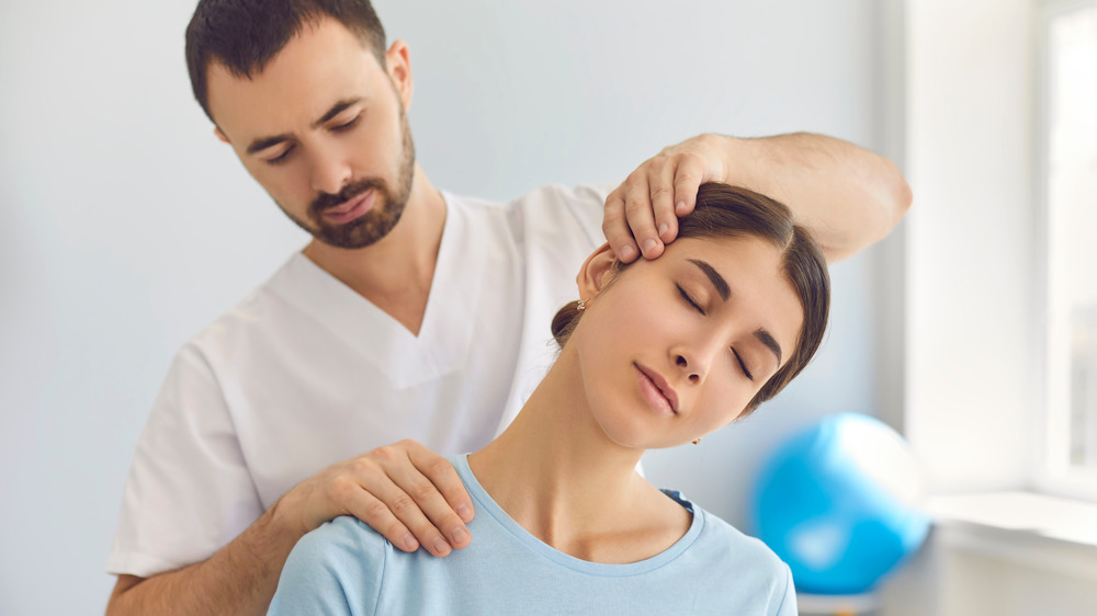 Chiropractor adjusting patient's neck