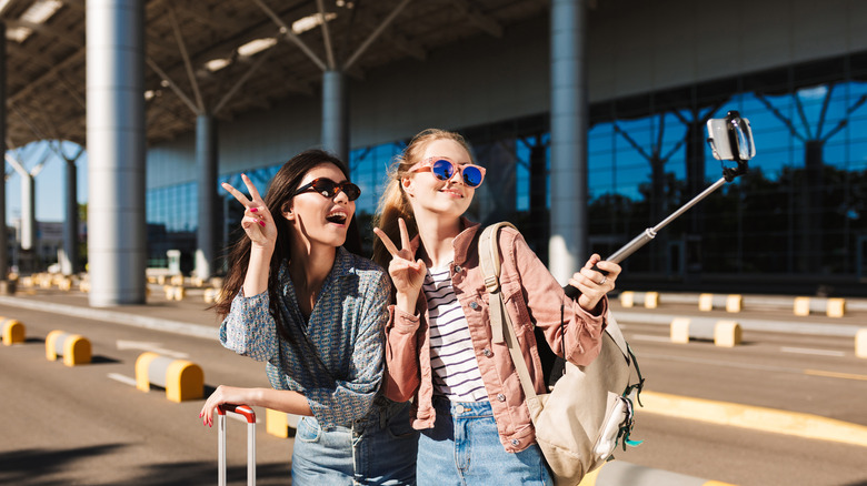 Two women wearing sunglasses at airport