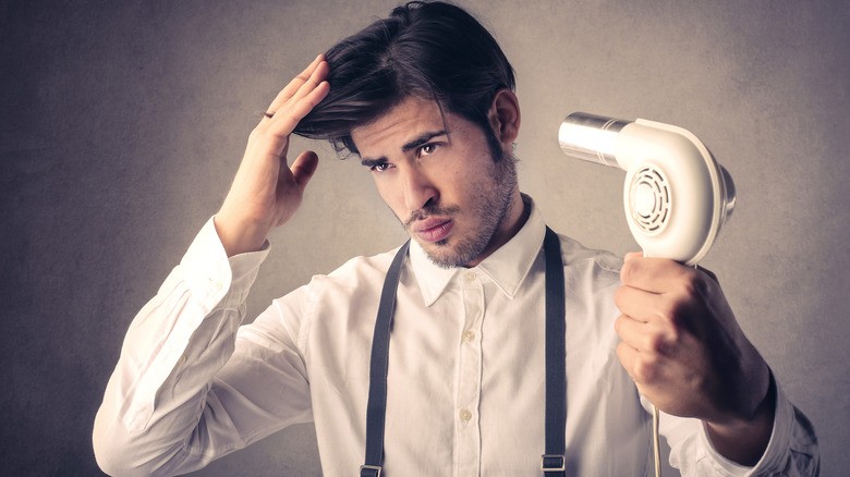 man blow-drying hair