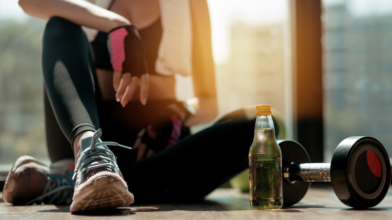 woman taking a break from weightlifting 