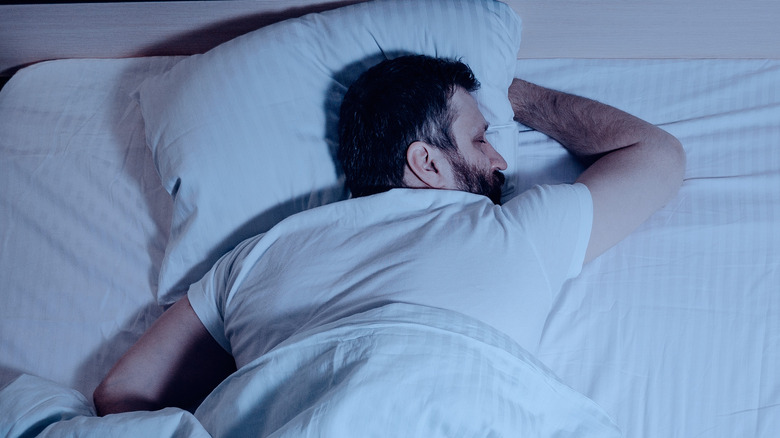 Man sleeping on his stomach in bed