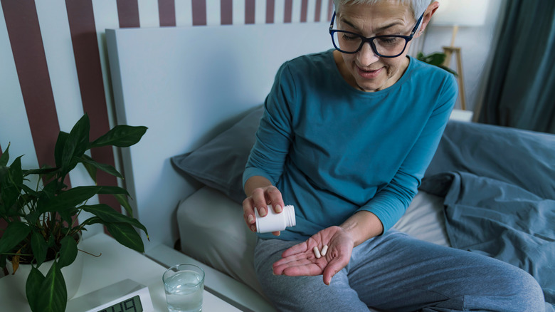 A woman takes melatonin before she goes to bed